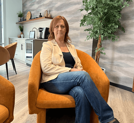 Sherry Hergott seated in a modern office